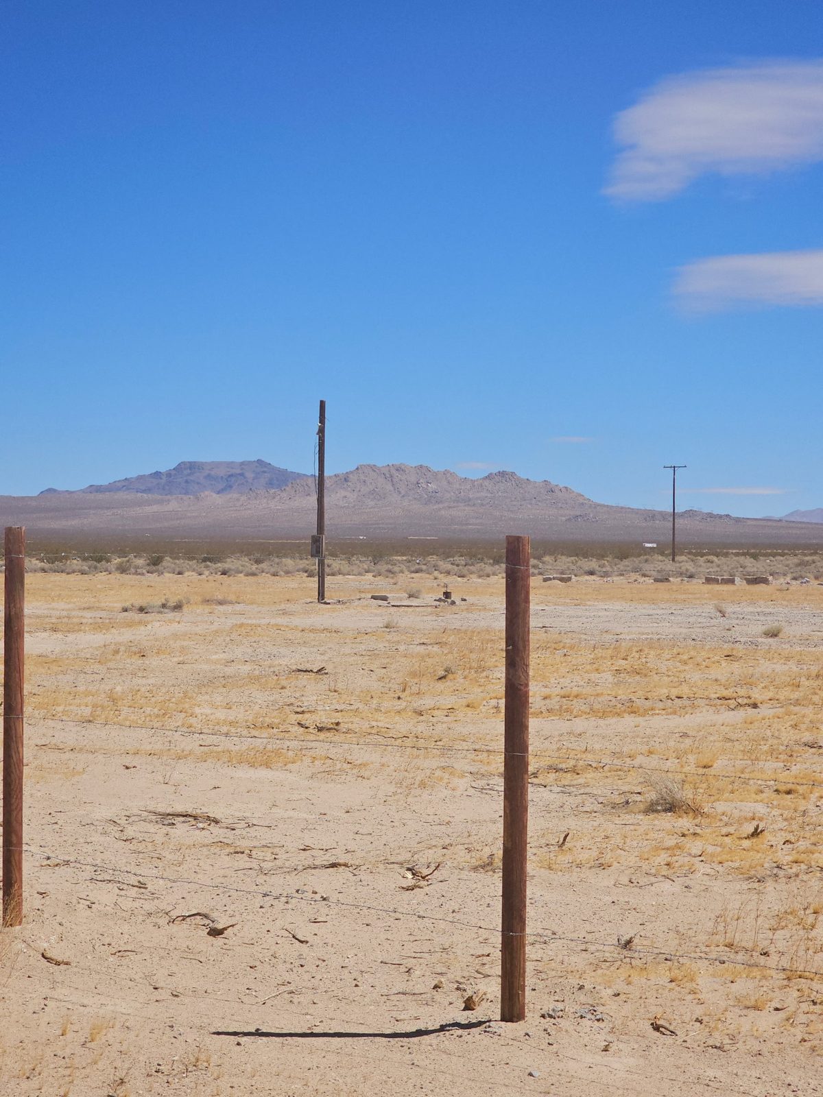 Utility pole and remnants of a concrete pad on the property